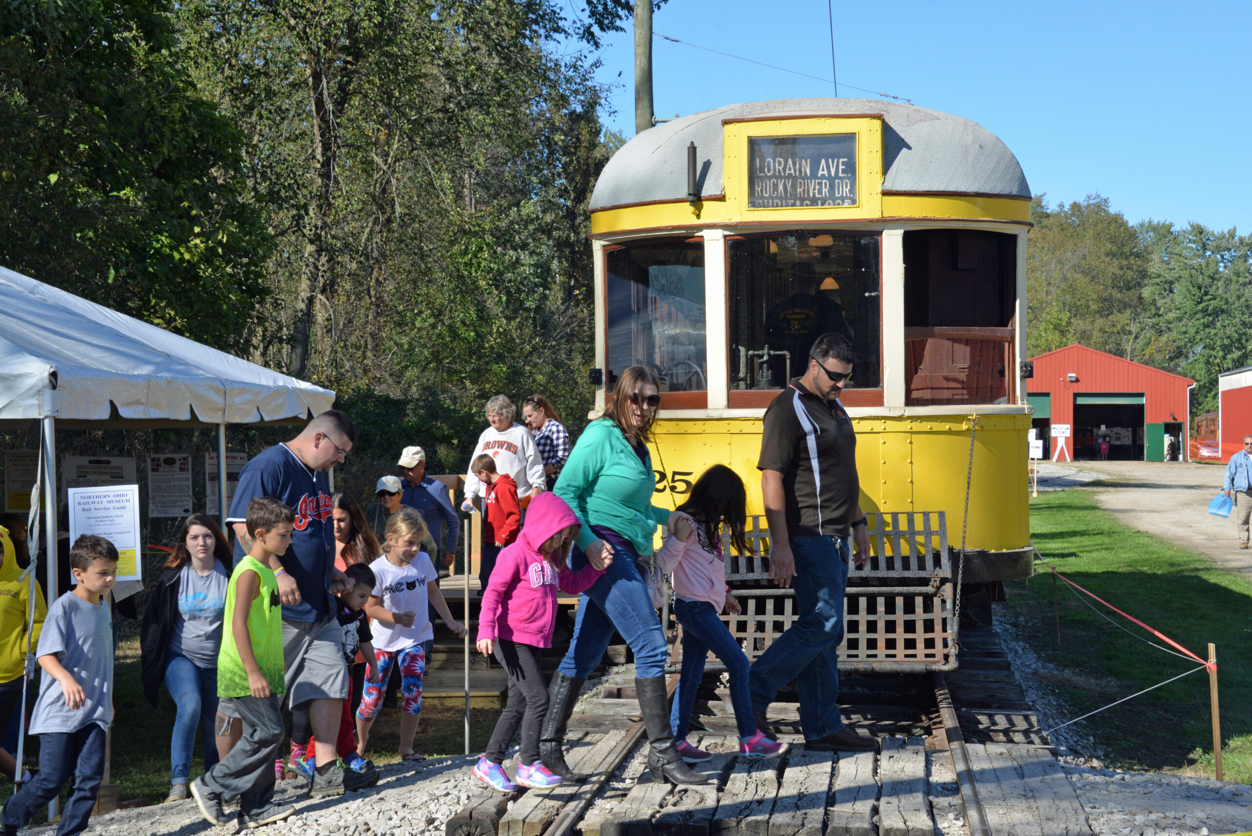 visitors walking past trolley